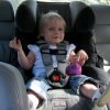 smiling child on car seat