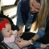 mom fixing baby on a car seat