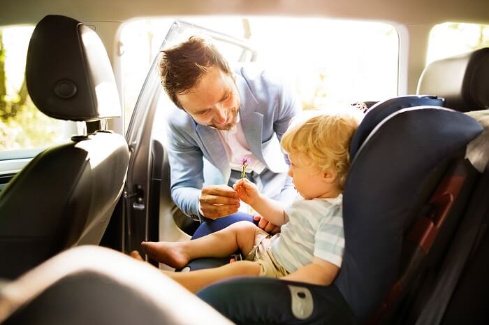 Father with son on car seat