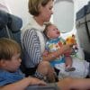 Baby, toddler, and a mother on a plane