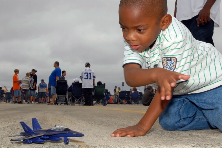 Toddler playing with a plane