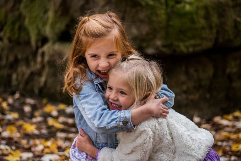 two girls hugging and playing