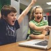 two children with a laptop