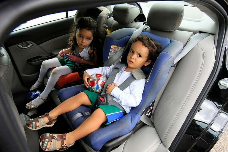 two toddlers on car seats