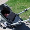 baby in a car seat with UV cover