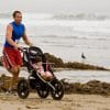 father running a marathon with baby in a stroller