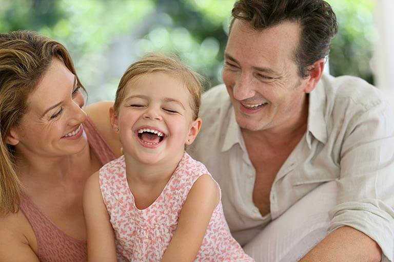 Portrait of happy family laughing together