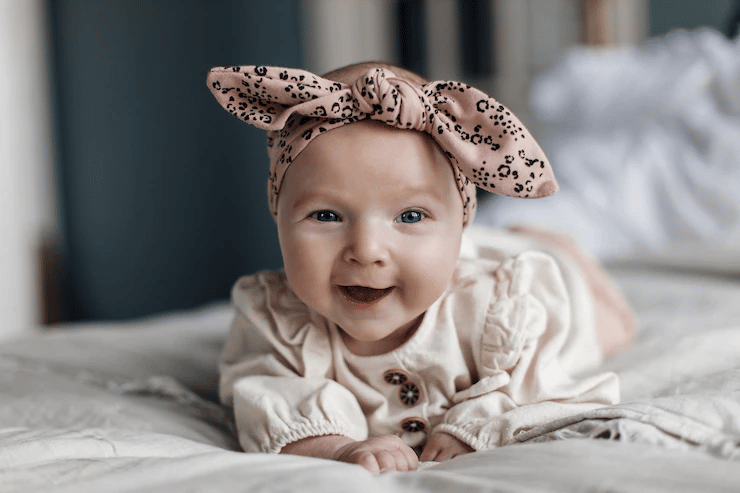 A baby smiling on the bed A baby smiling on the bed